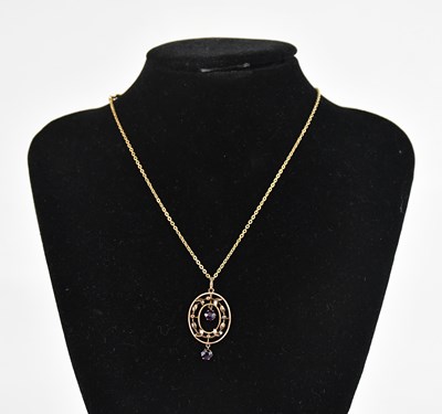 Lot 434 - An Edwardian 9ct gold pendant set with two...
