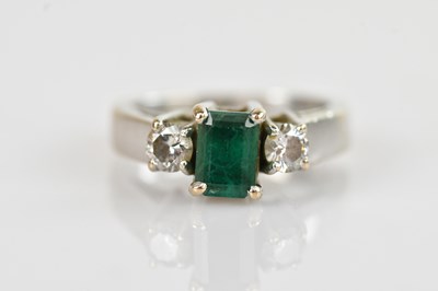 Lot 461 - A white metal diamond and emerald three stone...