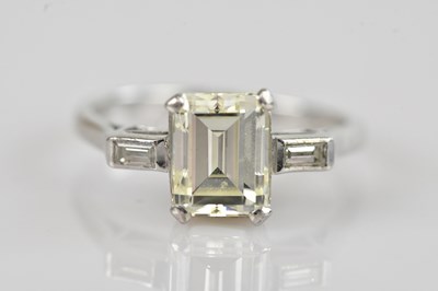 Lot 452 - A white metal diamond three stone ring, set...