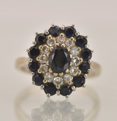 Lot 1327 - An 18ct white gold diamond and sapphire set...