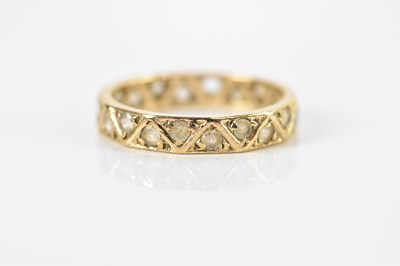 Lot 671 - A 9ct yellow gold eternity ring set with clear...