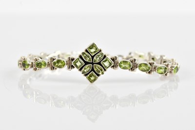 Lot 135 - A sterling silver peridot set fancy link...
