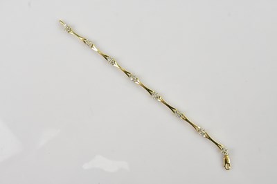 Lot 473 - A yellow metal diamond set bracelet, with...