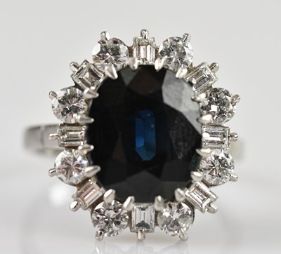 Lot 459 - An 18ct white gold diamond and sapphire...