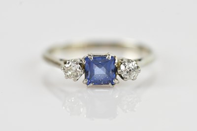 Lot 611 - A white metal diamond and blue stone ring, set...
