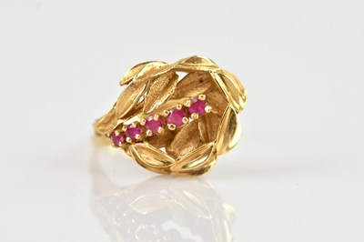 Lot 642 - A yellow metal dress ring set with five red...