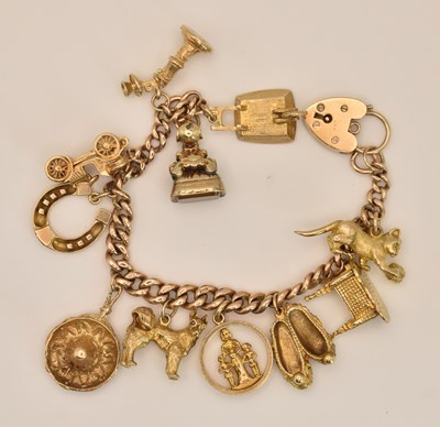 Lot 1511 - A 9ct rose gold charm bracelet with eleven...