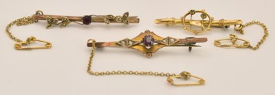 Lot 1506 - Three gold bar brooches, lengths ranging from...