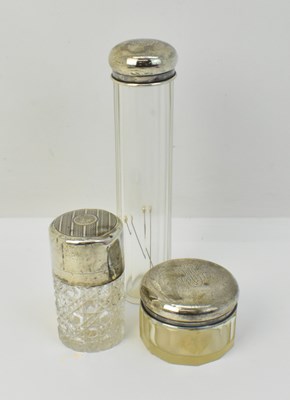 Lot 1280 - Three silver lidded cut glass dressing table...