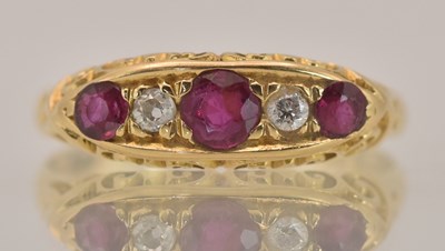 Lot 1364 - An 18ct yellow gold diamond and ruby set ring,...