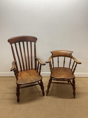 Lot 800 - Two elm kitchen elbow chairs, one in the style...