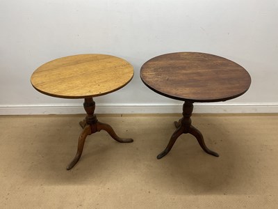 Lot 848 - Two oak tripod tilt-top tables, the dark oak...