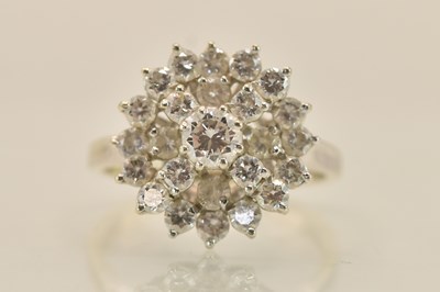 Lot 1257 - An 18ct white gold diamond set flower head...