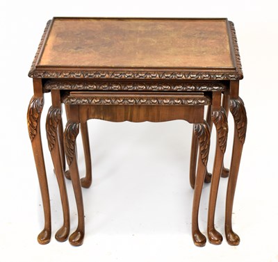 Lot 1749 - A nest of three walnut occasional tables of cabriole supports