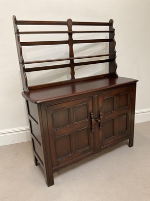 Lot 1015 - ERCOL; a stained dresser base, with two...