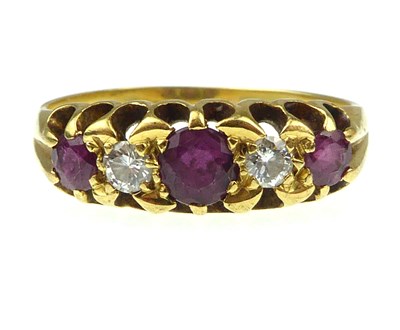 Lot 944 - An 18ct gold diamond and ruby set ring, the...
