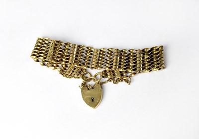 Lot 983 - A 9ct gold seven bar gate bracelet with 9ct...