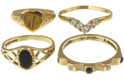 Lot 970 - Four 9ct gold rings comprising a modern...