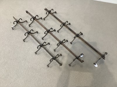 Lot 1296 - Three cast iron hanging coat racks, each with...