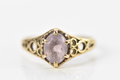 Lot 682 - A 9ct yellow gold dress ring set with a pale...