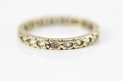Lot 698 - A yellow metal full eternity ring set with...