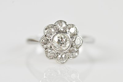 Lot 486 - A white metal diamond set daisy cluster ring,...