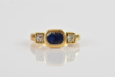 Lot 512 - A yellow metal diamond and sapphire three...