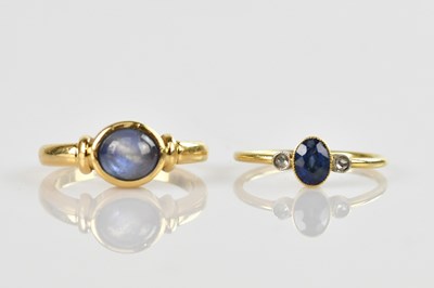 Lot 566 - A yellow metal dress ring set with a pale blue...