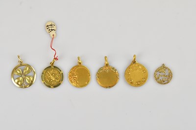 Lot 9 - Five yellow metal pendants including a pierced...