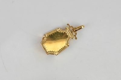 Lot 343 - A yellow metal locket pendant of shaped...