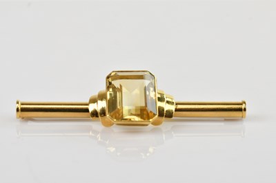 Lot 162 - A yellow metal bar brooch set with emerald cut...