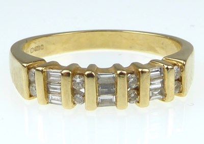 Lot 945 - A ladies' 18ct gold half eternity ring with...