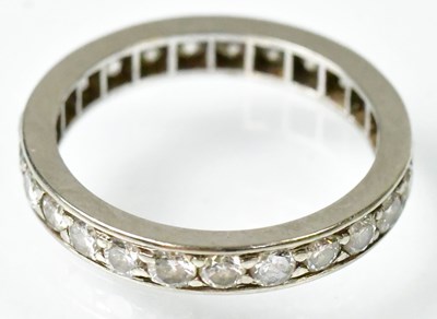 Lot 765 - A white metal eternity ring set with diamonds,...