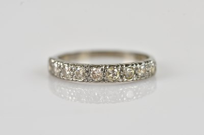 Lot 513 - A white metal nine stone diamond half eternity...