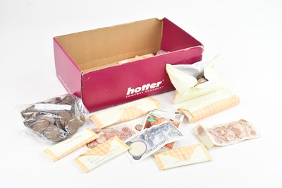 Lot 704 - A collection of assorted coins and banknotes,...
