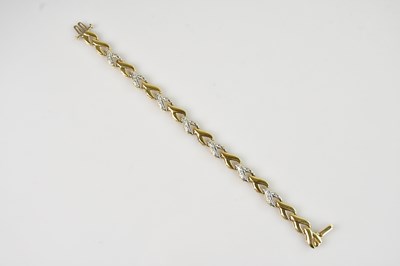 Lot 84 - A yellow and white metal bracelet, set with...