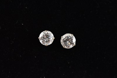 Lot 234 - A pair of white metal diamond ear studs, test...