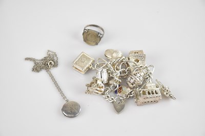 Lot 750 - A hallmarked silver charm bracelet with...
