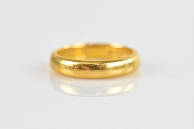 Lot 480 - A 22ct yellow gold wedding band, size N,...