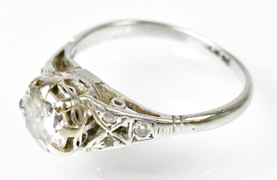 Lot 703 - A platinum ring set with a central diamond,...