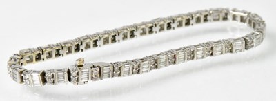 Lot 769 - An 18ct white gold tennis bracelet set with...