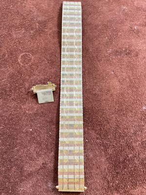 Lot 538 - A 9ct three tone gold broad flat link bracelet,...