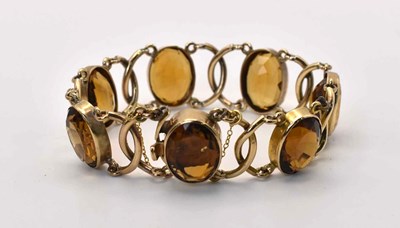 Lot 574 - A 9ct gold and smoky quartz bracelet, length...