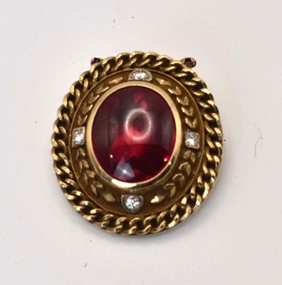 Lot 579 - A cabachon ruby and diamond brooch in a 10ct...