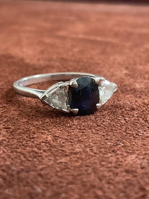 Lot 543 - An 18ct white gold sapphire and diamond three...