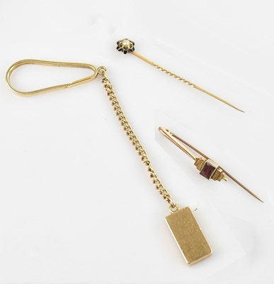 Lot 6 - A yellow metal clip with fancy link chain and...