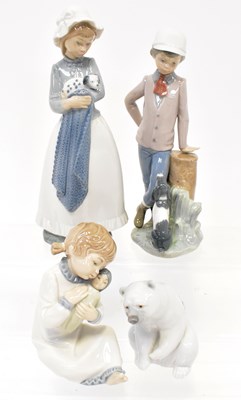 Lot 125 - NAO; three figures, comprising a young boy...