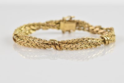 Lot 82 - A yellow metal fancy link twist bracelet,...