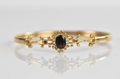 Lot 119 - A 9ct yellow gold bangle set with oval cut...