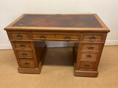 Lot 795 - A late 19th century oak knee-hole writing desk,...